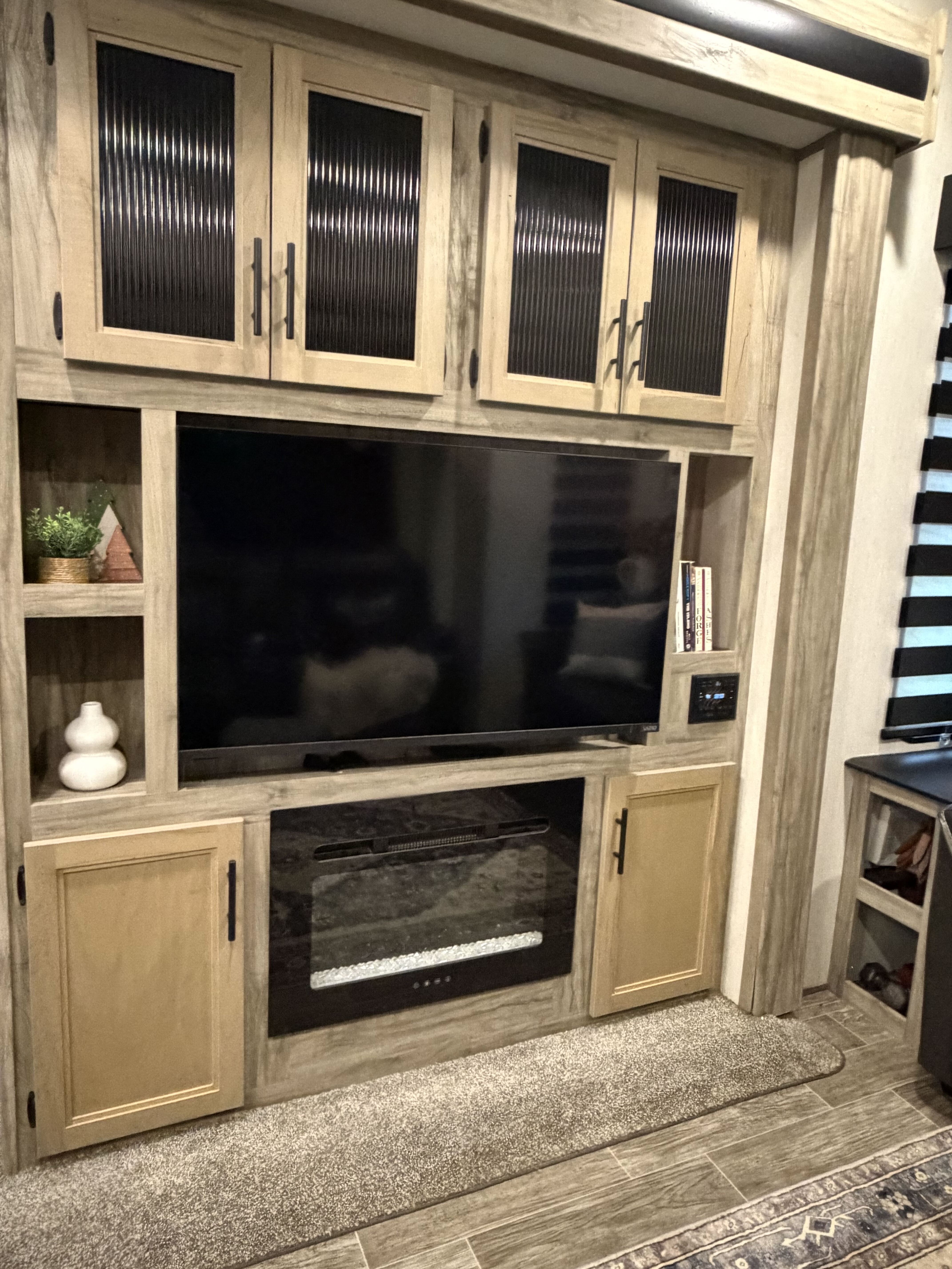 Entertainment center with television and electric fireplace
